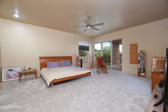 carpeted bedroom featuring access to exterior and ceiling fan