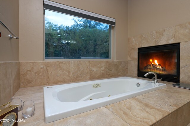 bathroom with tiled bath and tile walls