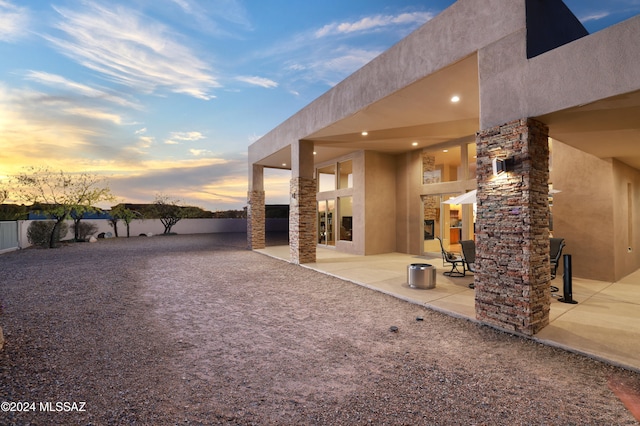 yard at dusk with a patio area