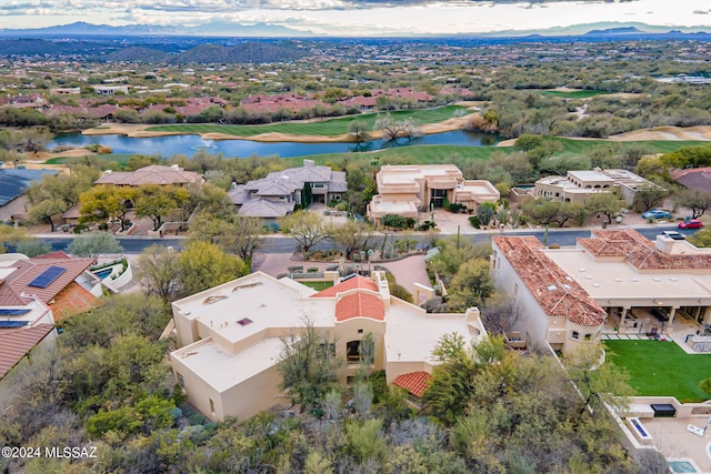 drone / aerial view featuring a water and mountain view