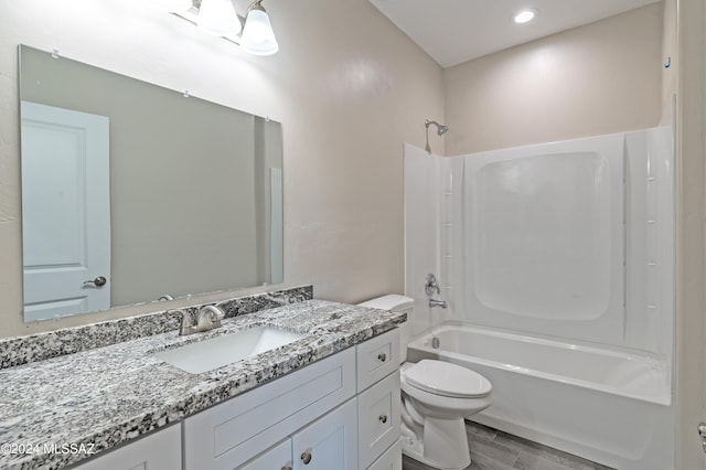 full bathroom featuring hardwood / wood-style flooring, vanity, toilet, and washtub / shower combination