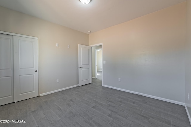 unfurnished bedroom with a closet and light hardwood / wood-style flooring