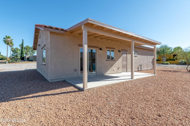 back of property with a patio