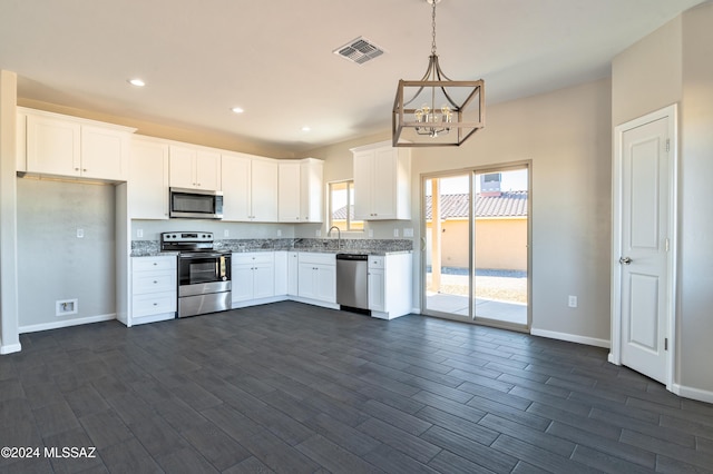 kitchen featuring stainless steel appliances, white cabinetry, and dark wood-type flooring