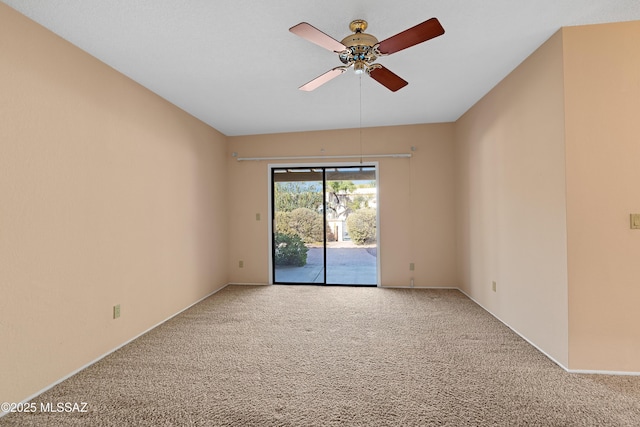 carpeted spare room with ceiling fan