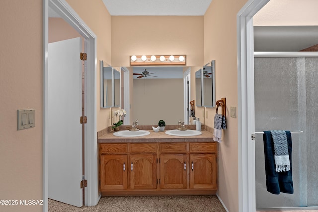 bathroom featuring ceiling fan, an enclosed shower, and vanity