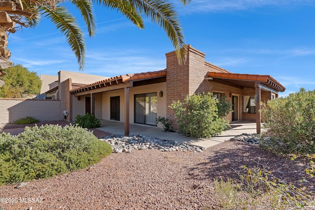 rear view of property featuring a patio area