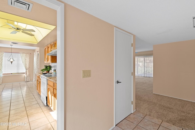 hall featuring light tile patterned flooring