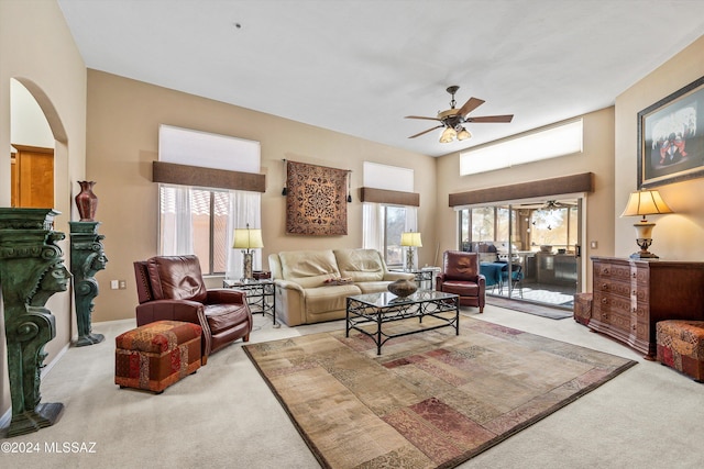 living room featuring a wealth of natural light, carpet, and ceiling fan