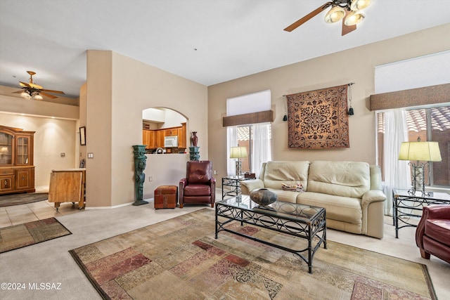 carpeted living room featuring ceiling fan