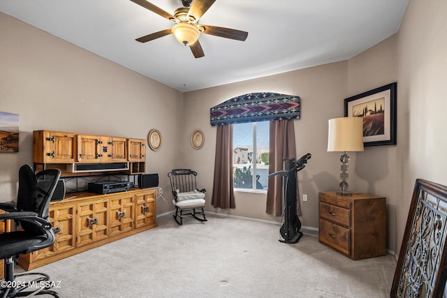 home office with light carpet and ceiling fan