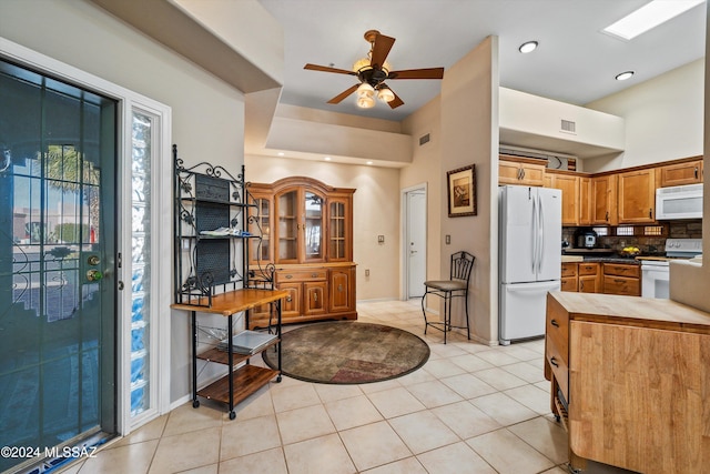 kitchen with ceiling fan, light tile patterned floors, and white appliances