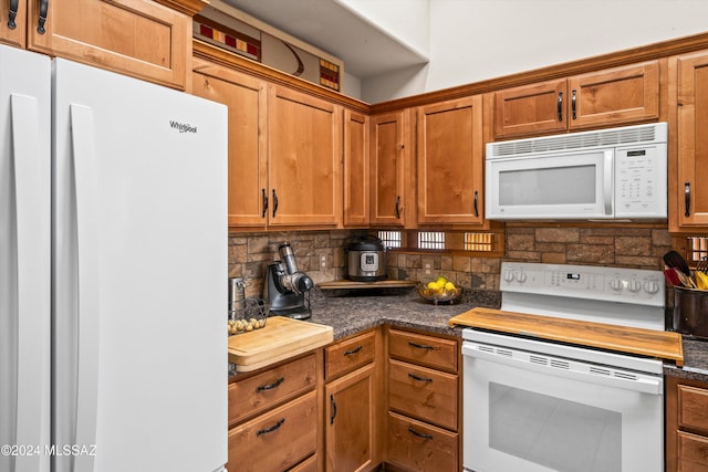 kitchen with decorative backsplash and white appliances