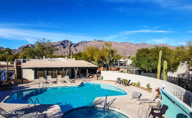 view of swimming pool with a mountain view and a patio area