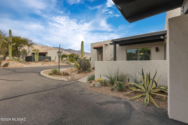 view of property exterior with a mountain view