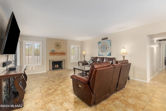 living room with a large fireplace and plenty of natural light