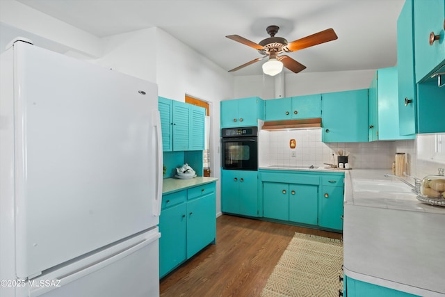 kitchen featuring ceiling fan, sink, dark hardwood / wood-style floors, decorative backsplash, and black appliances