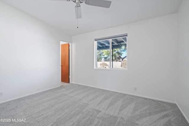 unfurnished room featuring ceiling fan and light colored carpet