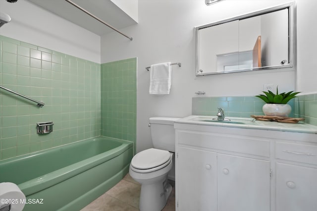 full bathroom with tile patterned flooring, vanity, toilet, and tiled shower / bath