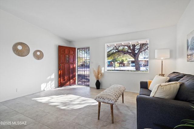 tiled living room featuring lofted ceiling