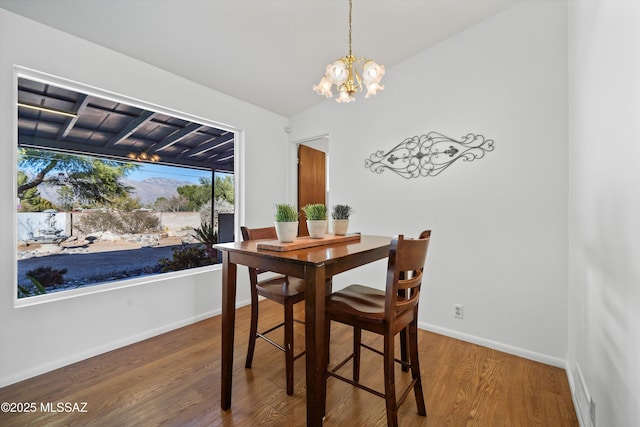 dining space featuring an inviting chandelier and hardwood / wood-style flooring