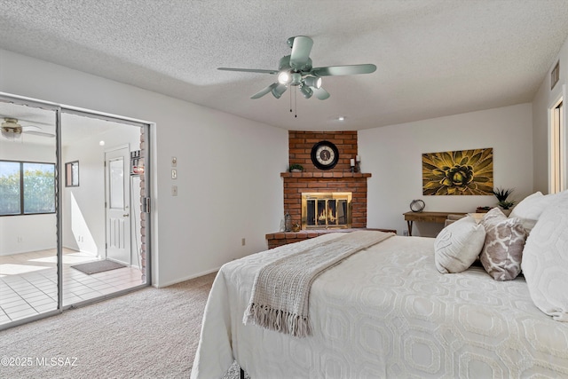 bedroom with ceiling fan, access to exterior, a fireplace, carpet floors, and a textured ceiling