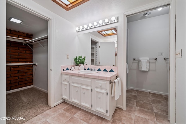 bathroom with vanity and a skylight