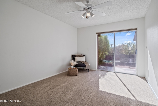 unfurnished room with ceiling fan, a textured ceiling, and carpet flooring