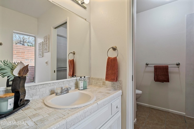 bathroom featuring tasteful backsplash, tile patterned floors, vanity, and toilet