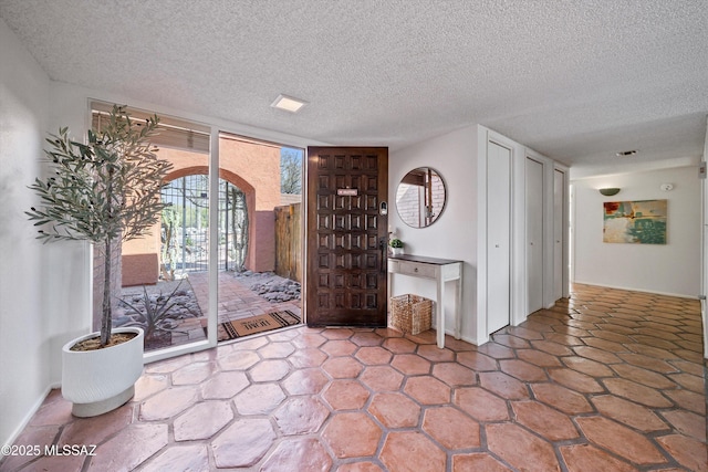 entryway featuring a textured ceiling