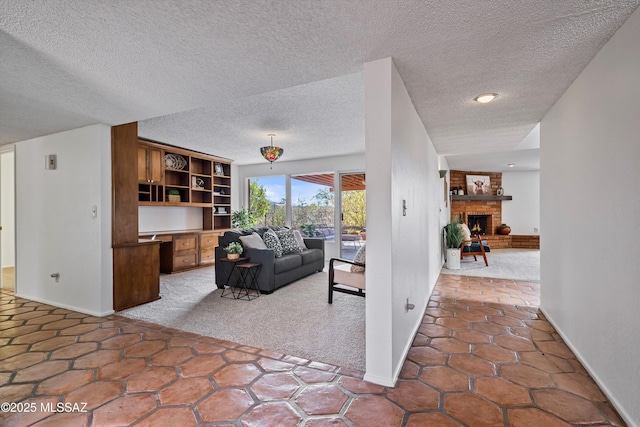 living room with carpet flooring, a textured ceiling, and a fireplace