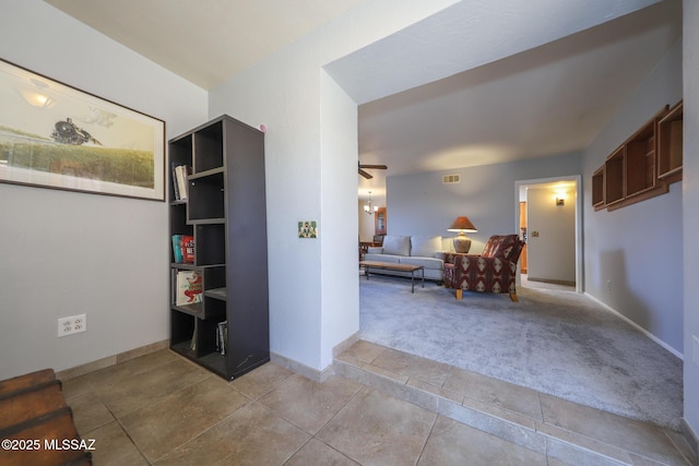 hallway with light colored carpet