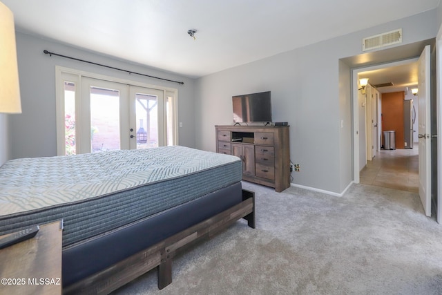 carpeted bedroom with access to exterior and french doors