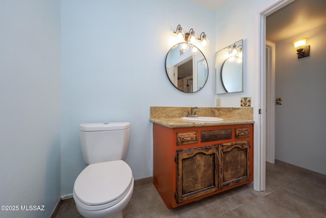 bathroom with tile patterned flooring, vanity, and toilet