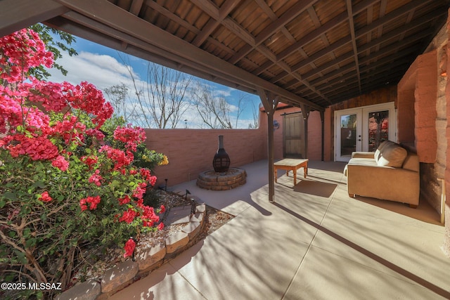 view of patio featuring french doors and a fire pit