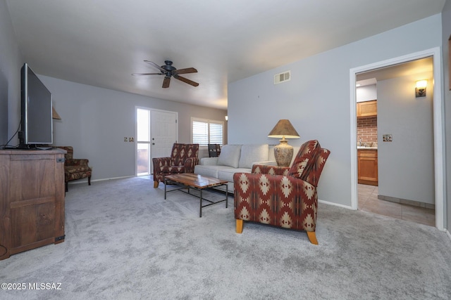 carpeted living room featuring ceiling fan