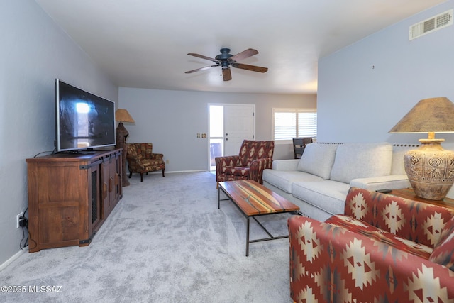 carpeted living room with ceiling fan