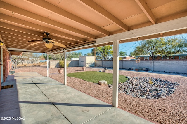 view of patio with ceiling fan and a storage shed