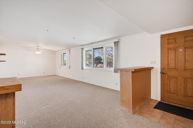 unfurnished living room with light colored carpet