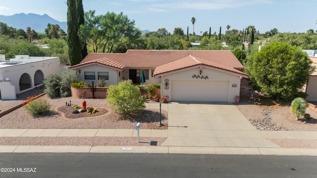 view of front of house with a mountain view and a garage