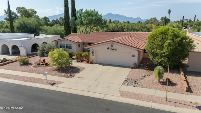 view of front facade with a mountain view and a garage