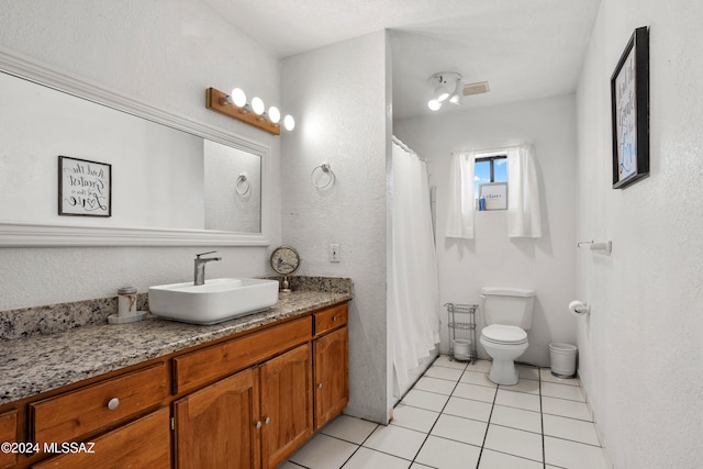 bathroom with tile patterned floors, vanity, and toilet