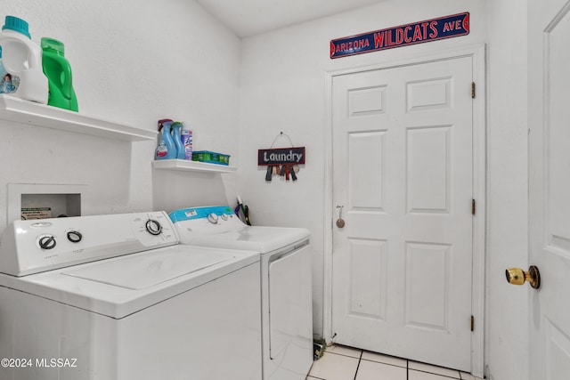 clothes washing area with washing machine and clothes dryer and light tile patterned floors