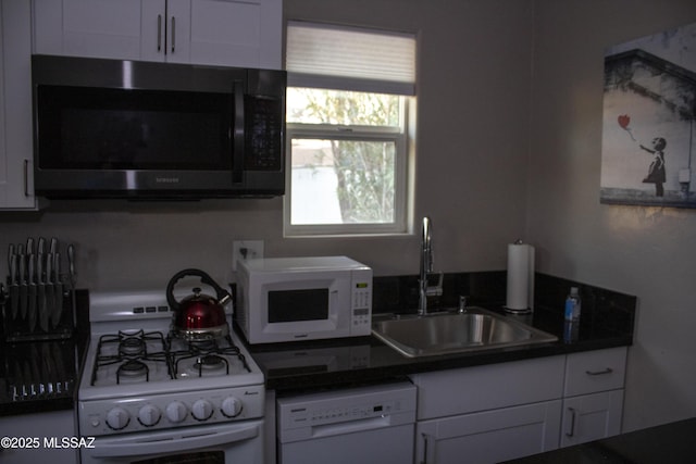 kitchen featuring white cabinets, white appliances, and sink