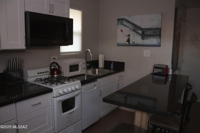 kitchen with white appliances, white cabinetry, and sink