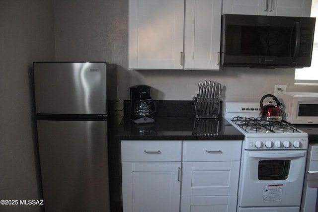 kitchen featuring white cabinets and white appliances