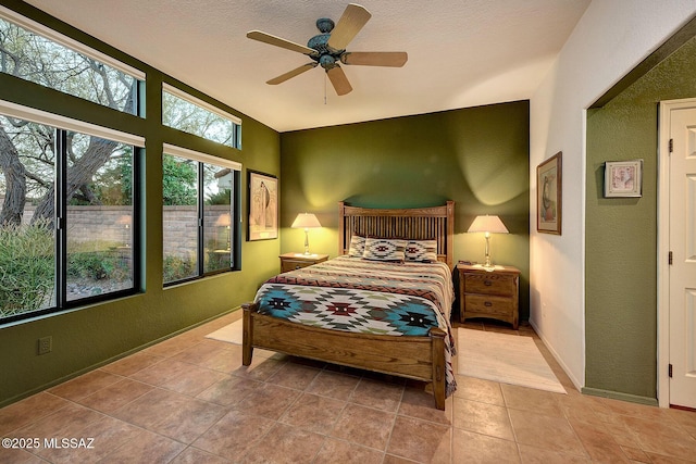 bedroom with light tile patterned floors and ceiling fan