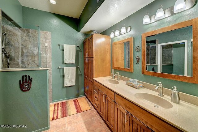 bathroom featuring a shower, tile patterned flooring, and vanity