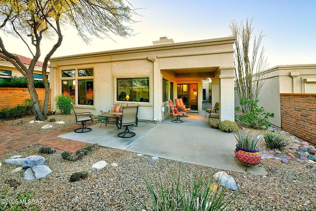 rear view of property featuring a patio