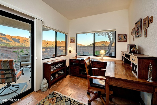 office space with a mountain view and light tile patterned floors